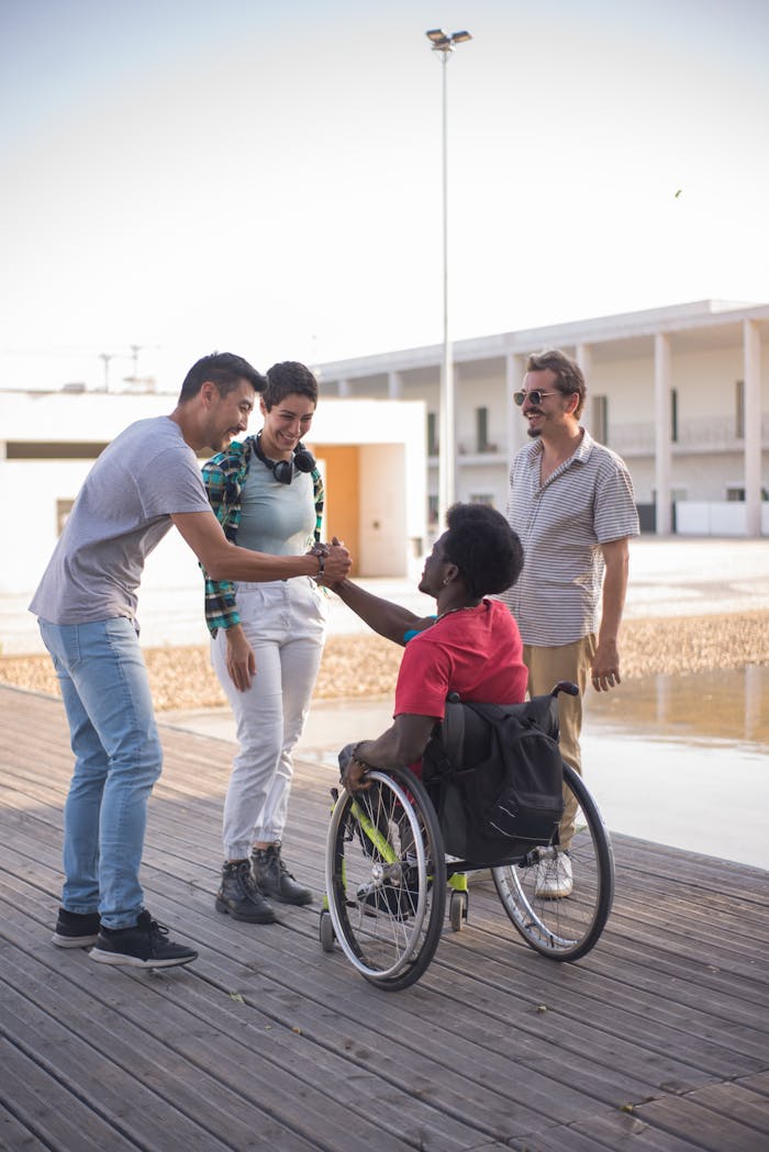 Diverse group of friends greeting each other in an outdoor setting, emphasizing inclusion and togetherness.